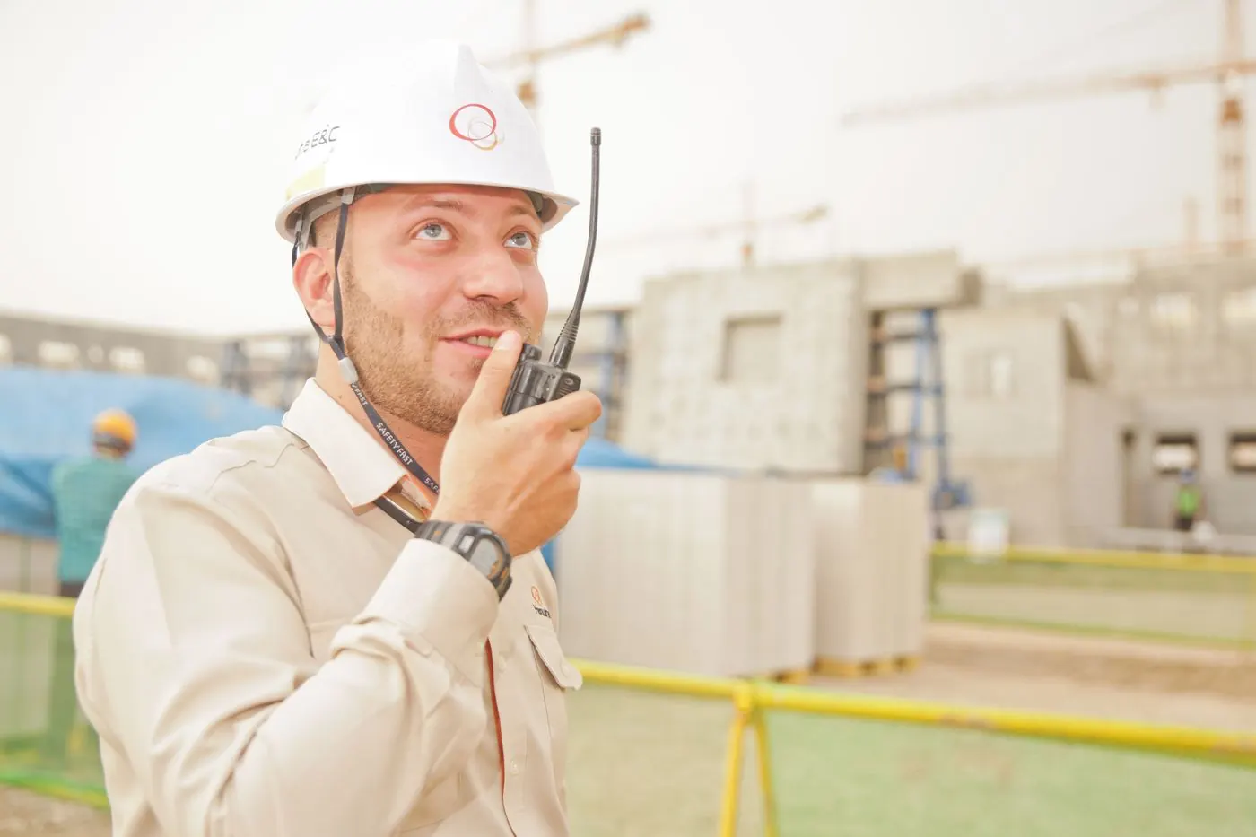 Construction worker using a two-way radio